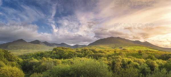 Large panorama with amazing sunset and dramatic sky at the foothill of Carrauntoohil mountain, MacGillycuddys Reeks mountains, Ring of Kerry, Ireland, Europe