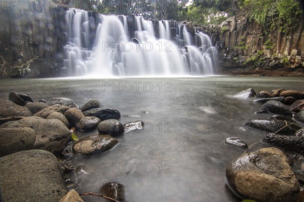 The waterfall is a 10 metre high waterfall that cascades over basal pillars into a basin. Tropical nature and landscape at Rochester Falls, Mauritius, Africa