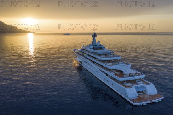 Aerial view 162, 5 metre long motor yacht ECLIPSE, delivered in 2010 by the Hamburg shipyard Blohm & Voss to the Russian oligarch Roman Abramovich, designer Terence Disdale, until 2013 the largest yacht in the world, at anchor at sunrise in the bay of Beaulieu-sur-Mer near Cap Ferrat, French Riviera, France, Mediterranean Sea, Europe