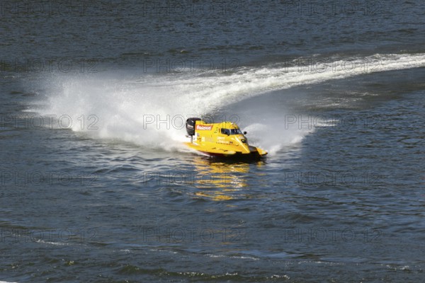 PESO DA REGUA, PORTUGAL - SEPTEMBER 15, 2024: Yellow Powerboat Makes Sharp Turn with Splashes of Water during Race. Formula 2 World Championship