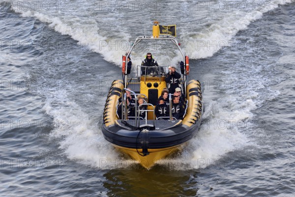 Speedboat with several people travelling at high speed across the water, London, London region, England, United Kingdom, Europe
