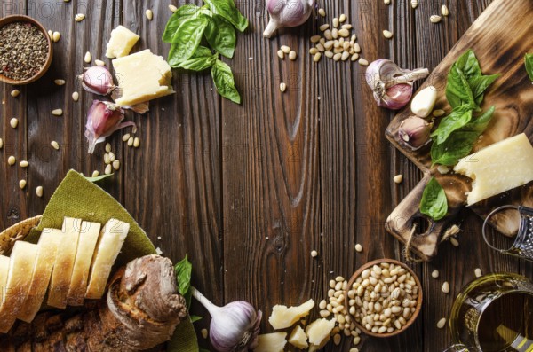 Flat lay view at food background of genovese pesto sauce ingredients on wooden kitchen table with copy-space
