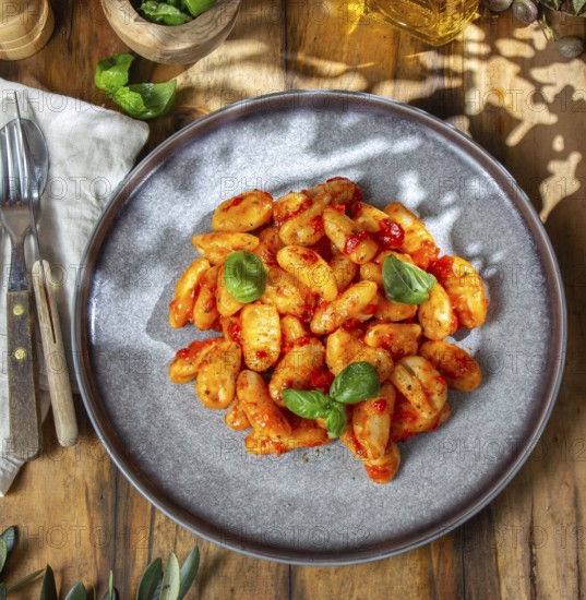 Food, Italian Gnocchi with tomato sauce and basil on wooden background