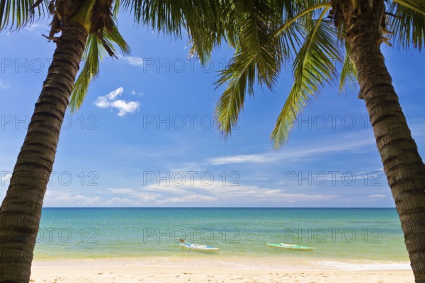Sand beach with palms and canoes in Phu Quoc close to Duong Dong, Vietnam, Asia