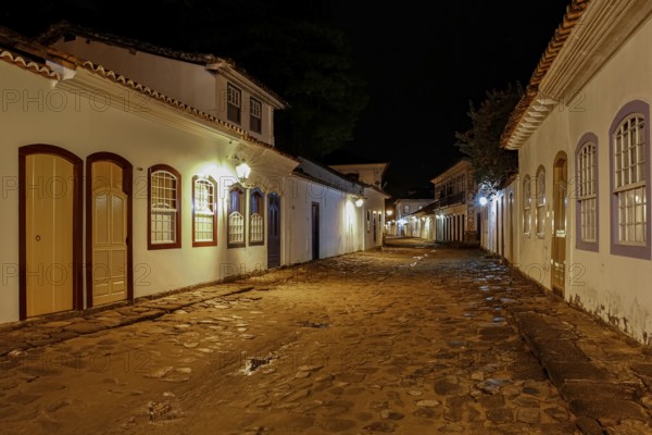 Atmospheric night view of illuminated street and buildings in historical center of Paraty, Brazil, Unesco World Heritage, South America