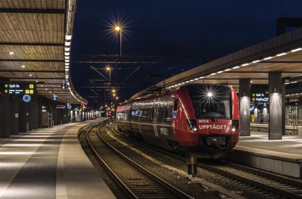 Uppsala, Uppland, Sweden, 07 27 2019 Train waiting at the platform at the Uppsala railwaytation by night, Europe