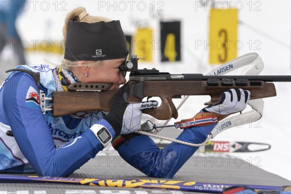 Biathlete Kseniya Petrunova rifle shooting in prone position. Biathlete in shooting range Junior biathlon competitions East of Cup. Petropavlovsk-Kamchatsky City, Kamchatka, Russia, April 12, 2019, Europe
