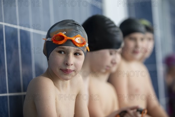 Belarus, the city of Gomel, March 10, 2021. School pool. A boy in a swimming cap looks at the camera, Europe
