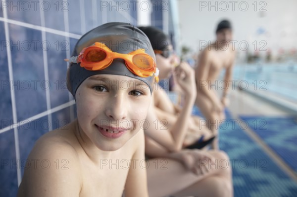 Belarus, the city of Gomel, 10 March 2021. School swimming pool. A boy with a swimming cap looks into the camera, Europe