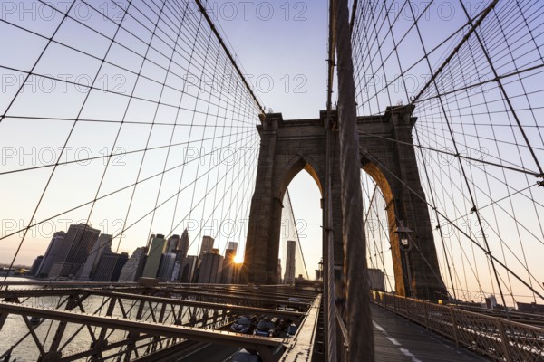 Brooklyn Bridge sunset with Manhattan skyline of New York City USA