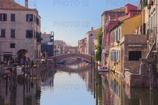Bridge over canal in Chioggia, Italy. Typical Italian houses and gondolas, Chioggia, Italy, Europe