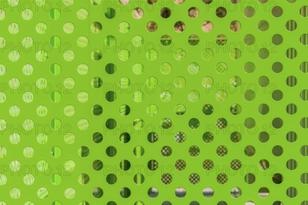 Closeup of green honeycombed fence with blurred background