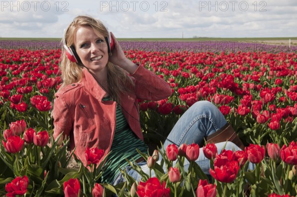 Dutch girl with long blond hair is listening to music