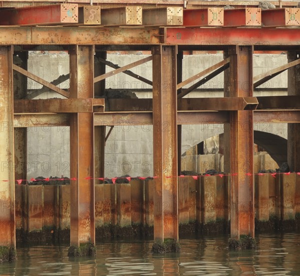 Bridge construction detail with massive steel girders anchored in the ground