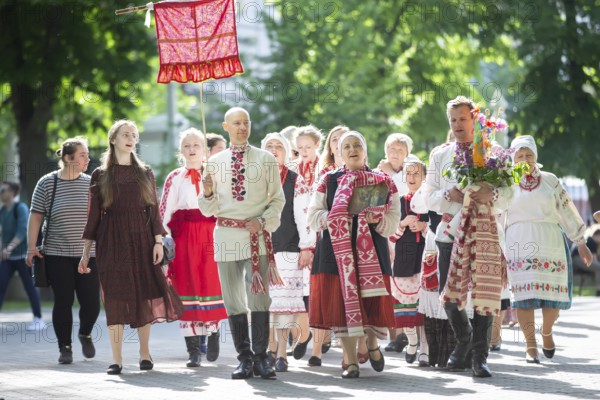 People in Belarusian national costumes perform a national ethnic ritual