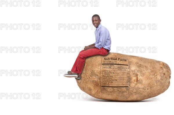 Handsome young black teenager sitting on a potato