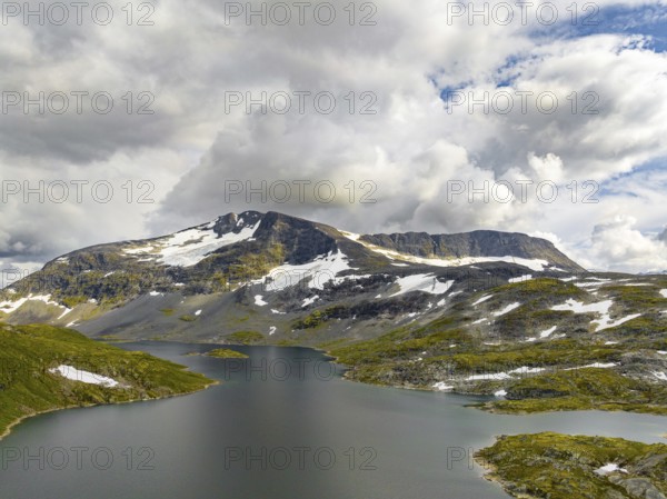 Typical fjord landscape in norway with high snow covered mountains and deep lakes