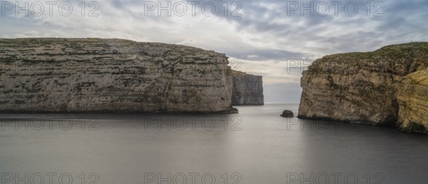 A panorama landscape view of Dwejra Bay and Ufo Rock on Gozo Island in Malta