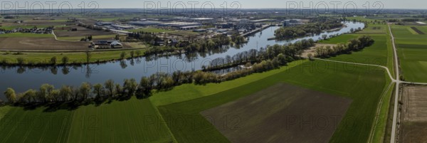 Aerial view of a river course (Danube) through fields, with industrial areas in the background, Bogen, Lower Bavaria, drone shot