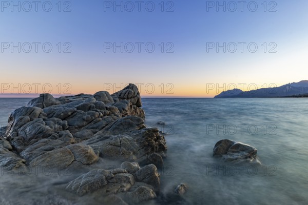 Rocks in the sea on the beach of Torre di Bari at sunset, long exposure, Torre di Bari, Bari Sardo, Ogliastra, Sardinia, Italy, Europe
