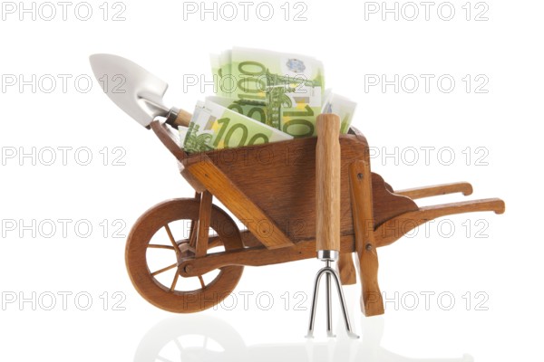 Gardening with euros in wheelbarrow isolated over white background