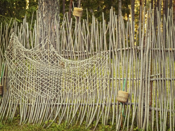 Fence with fishing net in the forest