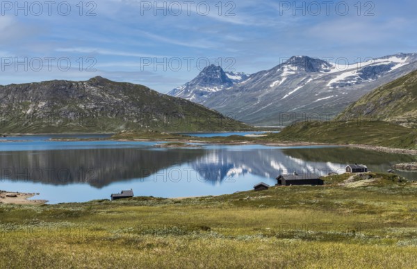 Walking track in national park from bitihorn to stavtjedtet with lakes fjord and snow on the mountains