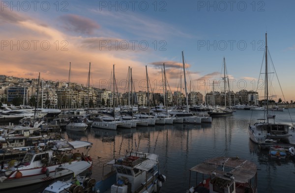 Freattyda, Athens, Greece, 12 28 2019 Golden hour landscape view over the marina of Piraeus with boats and pink clouds, Europe