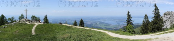 Upper Bavaria, Chiemgau Alps, Germany, June 4, 2022, panoramic view with KAB mountain cross Kampenwand on the foothills of the Alps with Lake Chiemsee, Europe