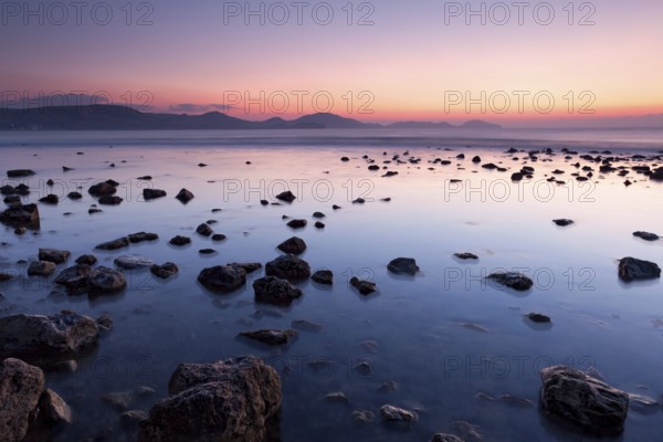 Colorful sunrise on the rocky sea coast