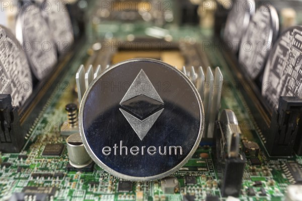 Ethereum coin close-up on a computer circuit motherboard as a blockchain technology payment network. Digital cryptocurrency concept and mining