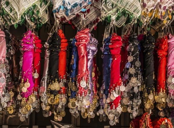 Plenty of fake gold coins are on the scarf edges