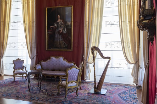 Venaria Reale, Italy, February 2023: luxury interior, old Royal Palace. Perspective with harp, window and baroque decoration, Europe