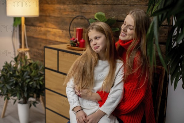 A warm and cozy indoor scene beautifully capturing a mother and daughter joyfully sharing sweet moments together