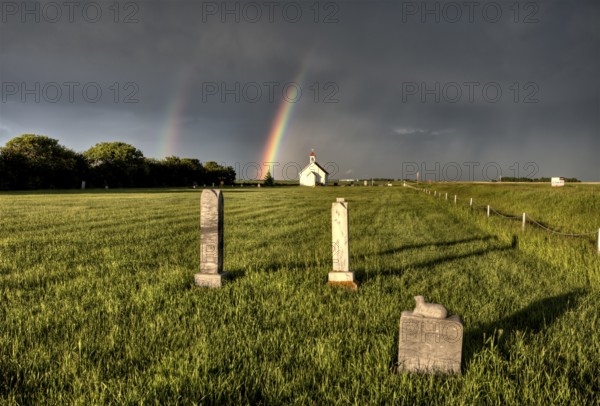 Old Country Church in Saskatchewan Canada with storm clouds rainbow