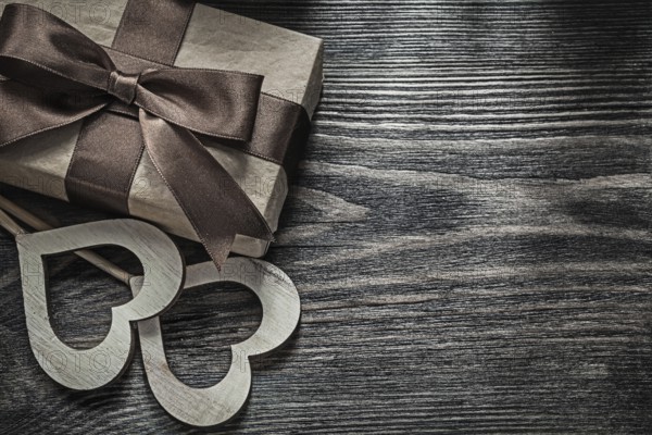 Present box white wooden hearts on vintage wood board celebrations concept