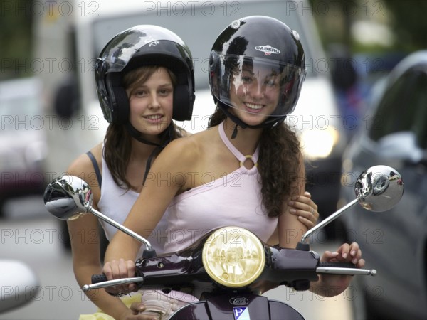 Two woman riding a scooter, Barcelona, Spaina