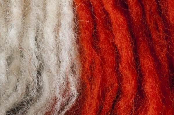 White and red wool fibers closeup
