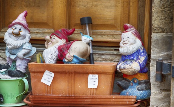 Garden gnomes in front of a door in a French village, 2019
