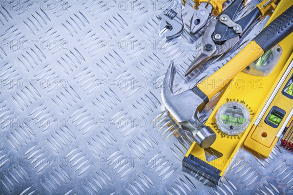 Set of construction tools on grooved metal plate maintenance concept