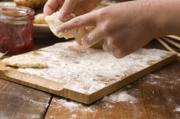 Detail of hands kneading dough, lodz, poland
