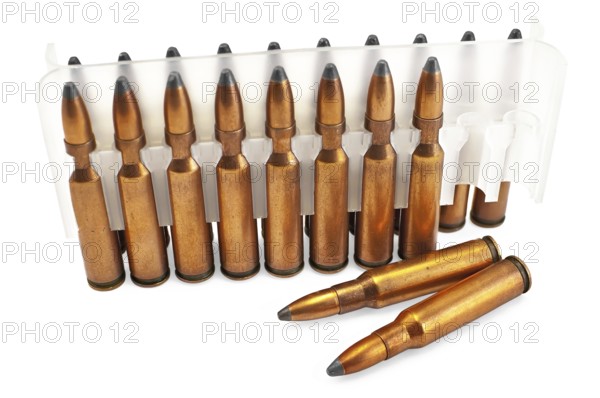 Packing ammunition for the automatic weapons and two cartridges lie separately isolated on a white background