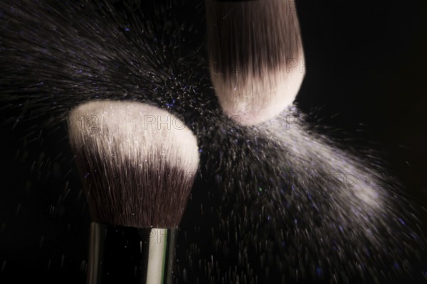 Cosmetics brush and colorful makeup powder