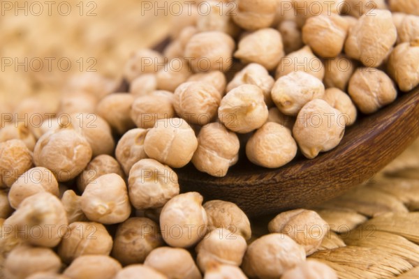 Dried white chickpeas ceci on the wooden spoon, lodz, poland