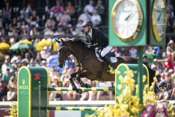 Daniel Coyle of Ireland and riding Legacy compete in the first round of the 1.60m CPKC International during the Spruce Meadows Masters, presented by Rolex, in Calgary, Alberta, Canada, North America