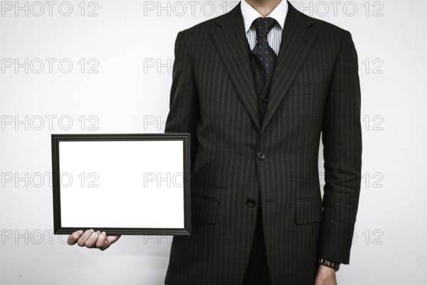 Businessman with a white board. Shooting Location: Tokyo metropolitan area