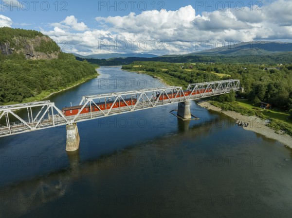 Railroad bridge with 4 permanently parked train wagons over the Namsen river in Norway