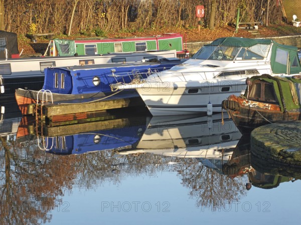 Old narrow boats converted to houseboats moored in the marina at brighouse basin in west yorkshire