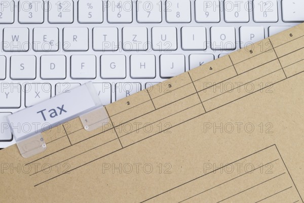 The photo shows a white keyboard with a tax briefcase