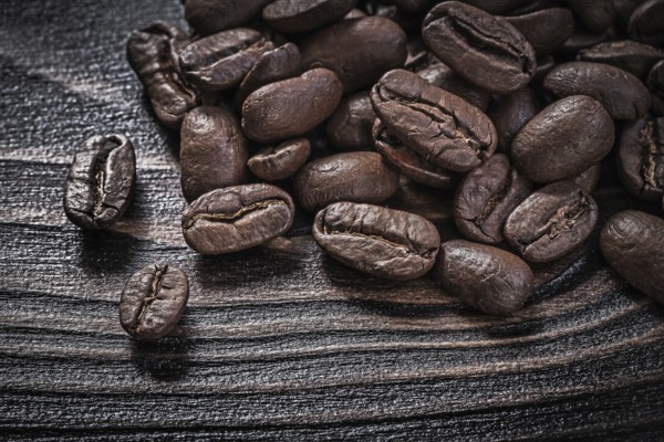 Coffee beans on vintage wood board food and drink concept